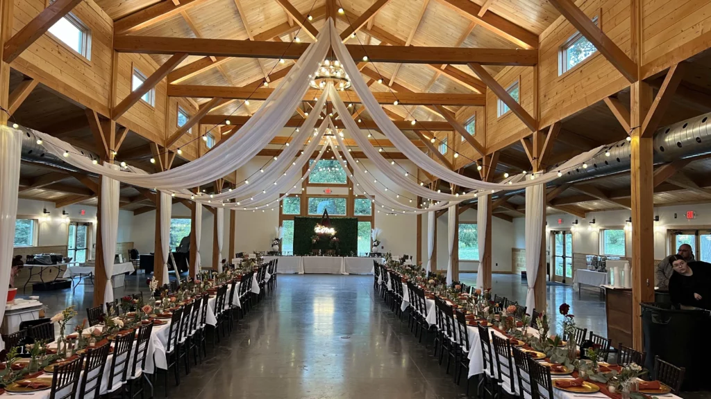 Interior of Lilac Hill’s rustic barn, a wedding venue Omaha and event space Omaha, decorated for a romantic reception with elegant table settings and soft lighting.